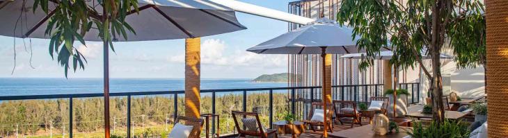 Tables and lounge chairs overlooking the ocean